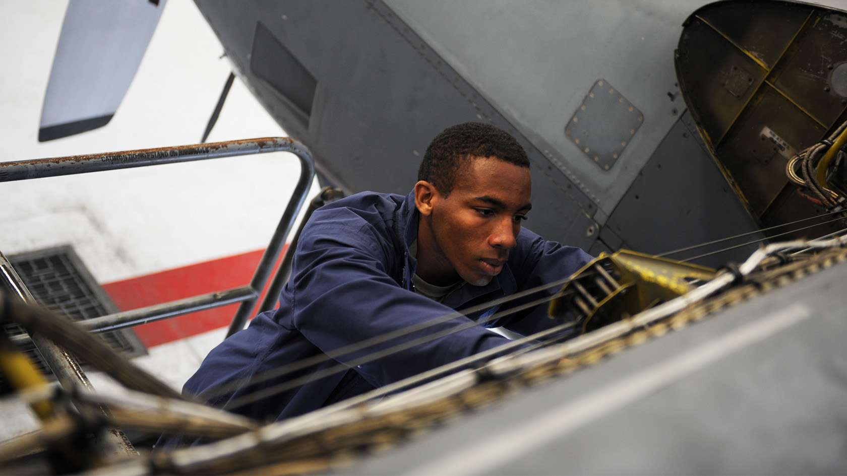 airman performing maintenance on the aircraft's fuel system
