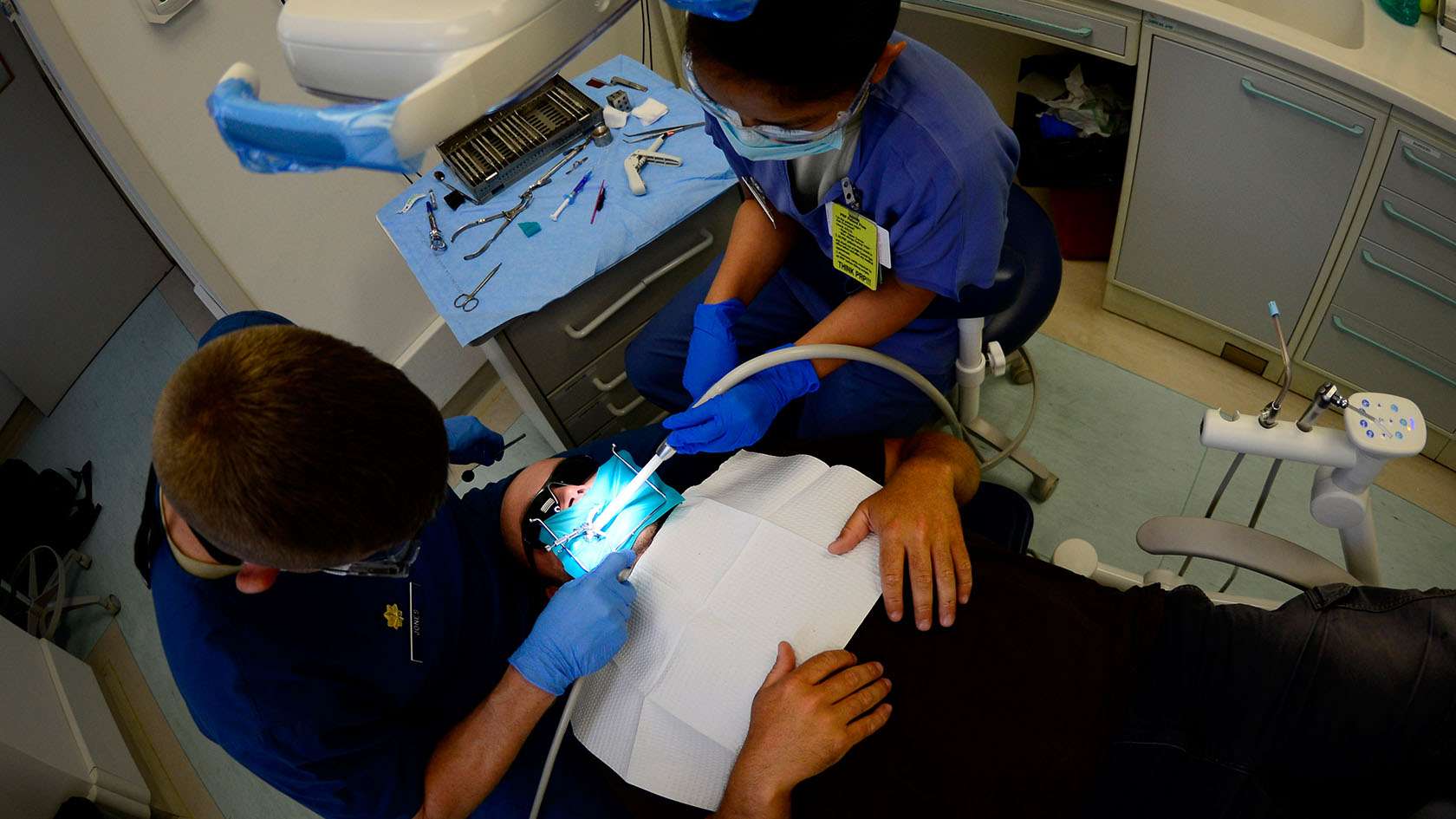 dental assistant helping dentist with a patient