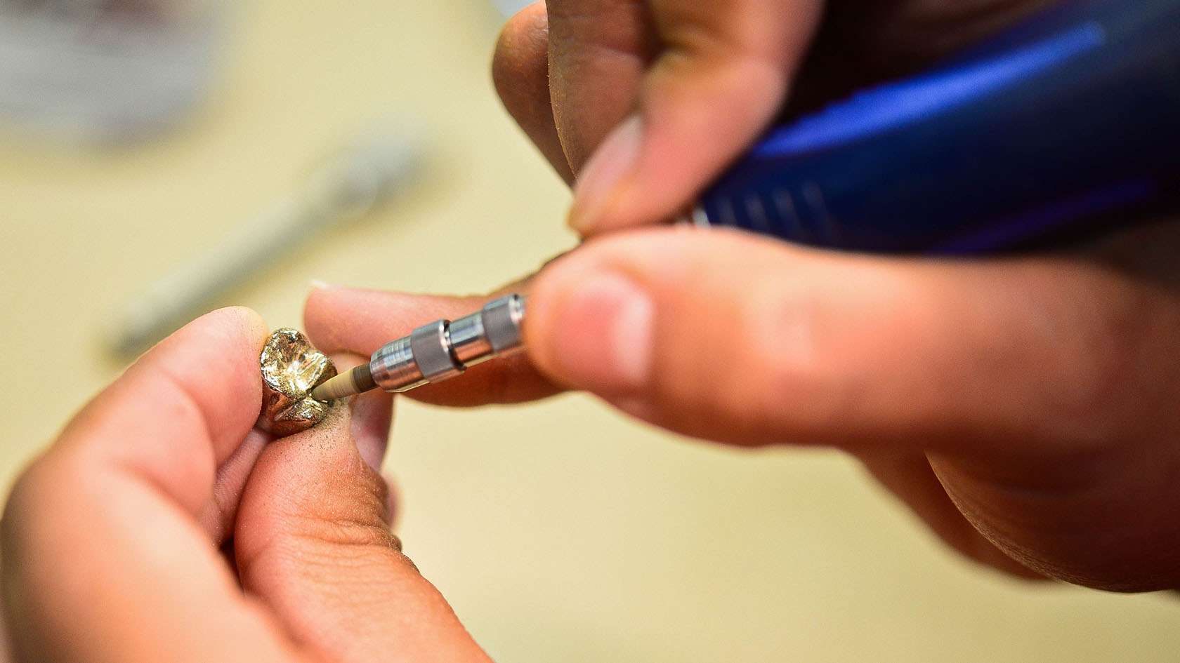 dental lab specialist working on a crown