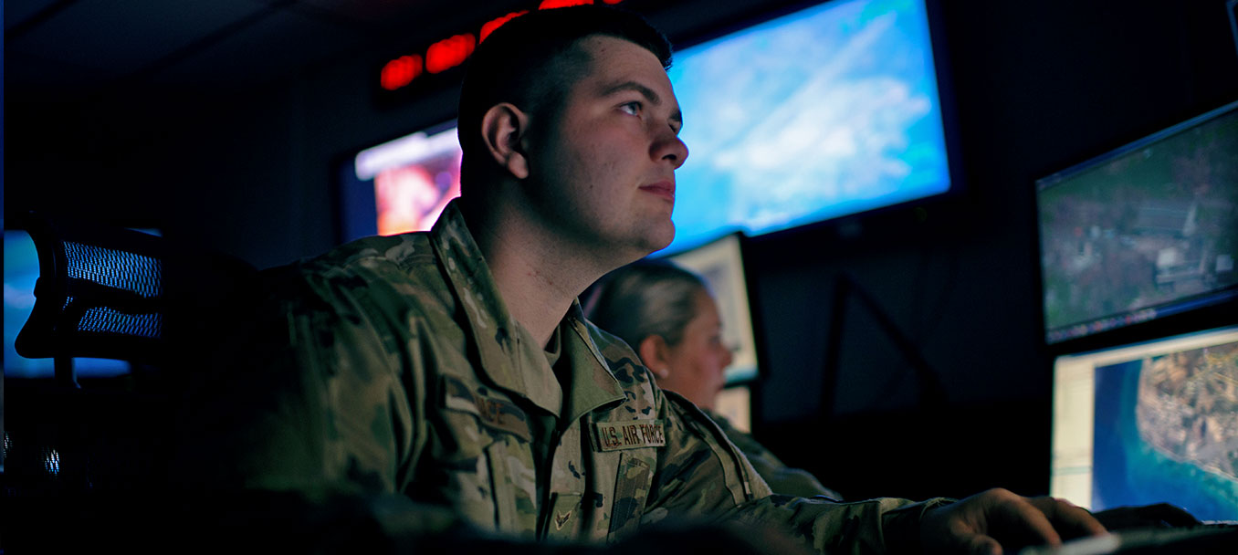 ALL SOURCE INTELLIGENCE ANALYSTS LOOKING AT MONITORS