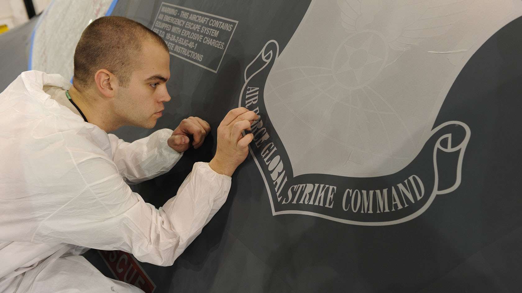 airman performing aircraft maintenance