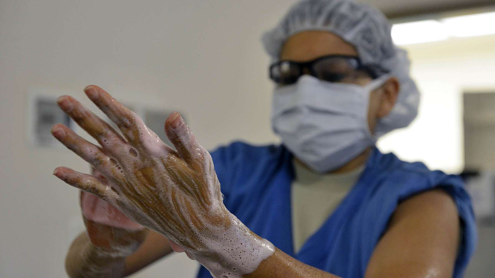 airman washing hands prior to surgery