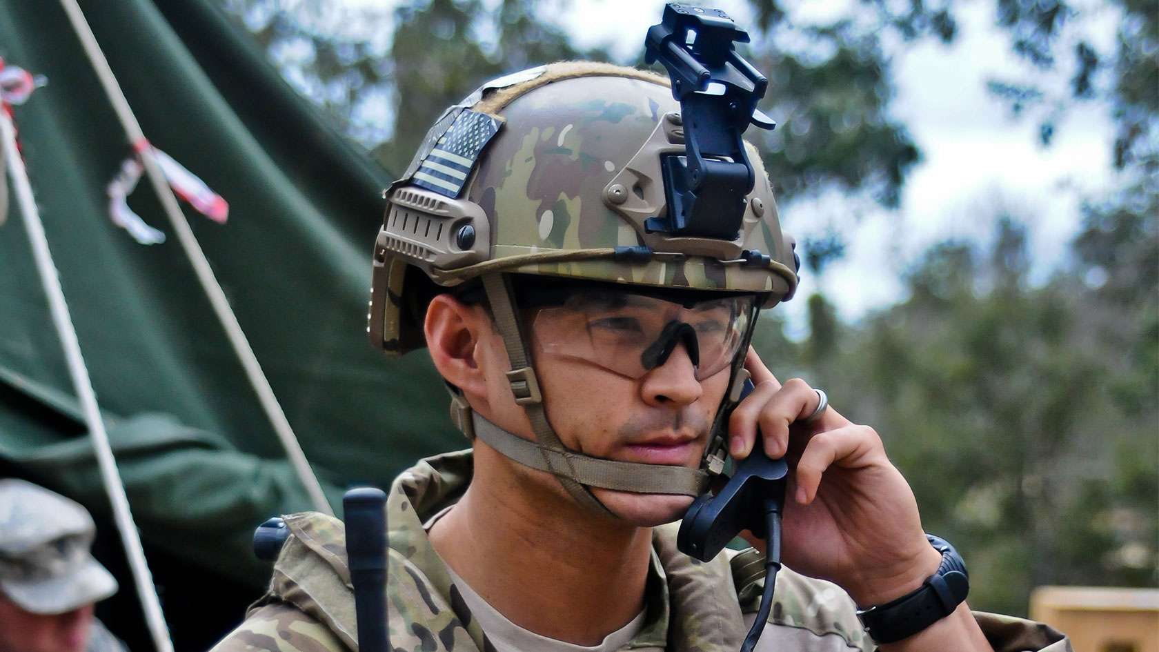 TACP Officer in helmet talking on satellite phone