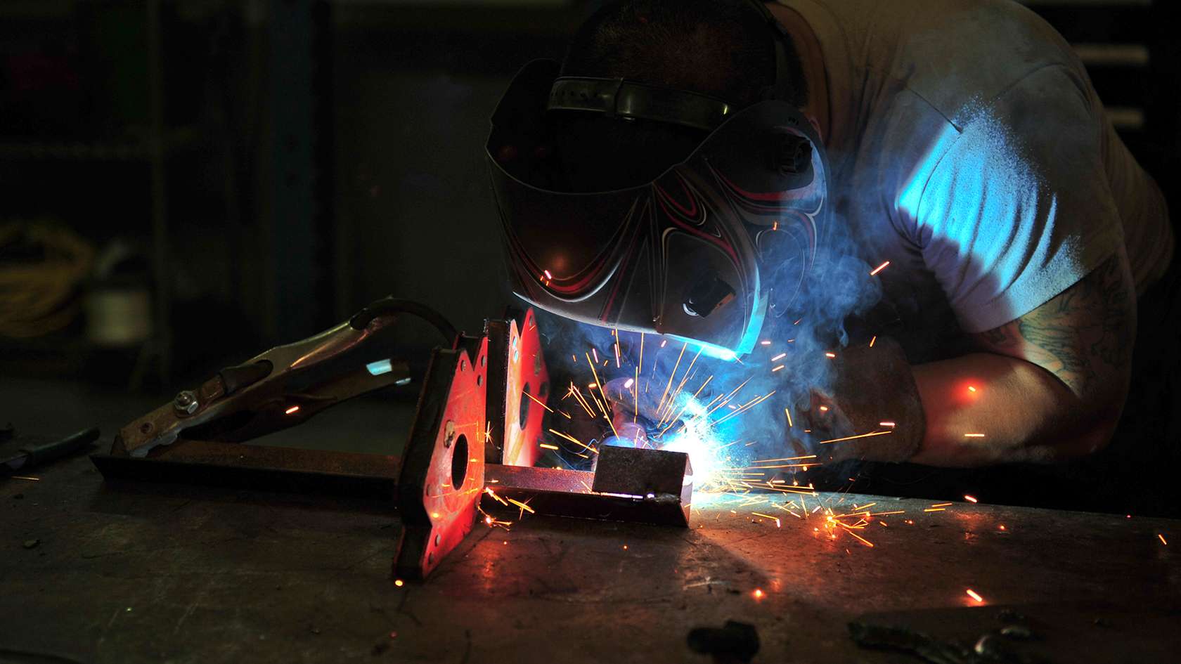 airman making repairs under a truck
