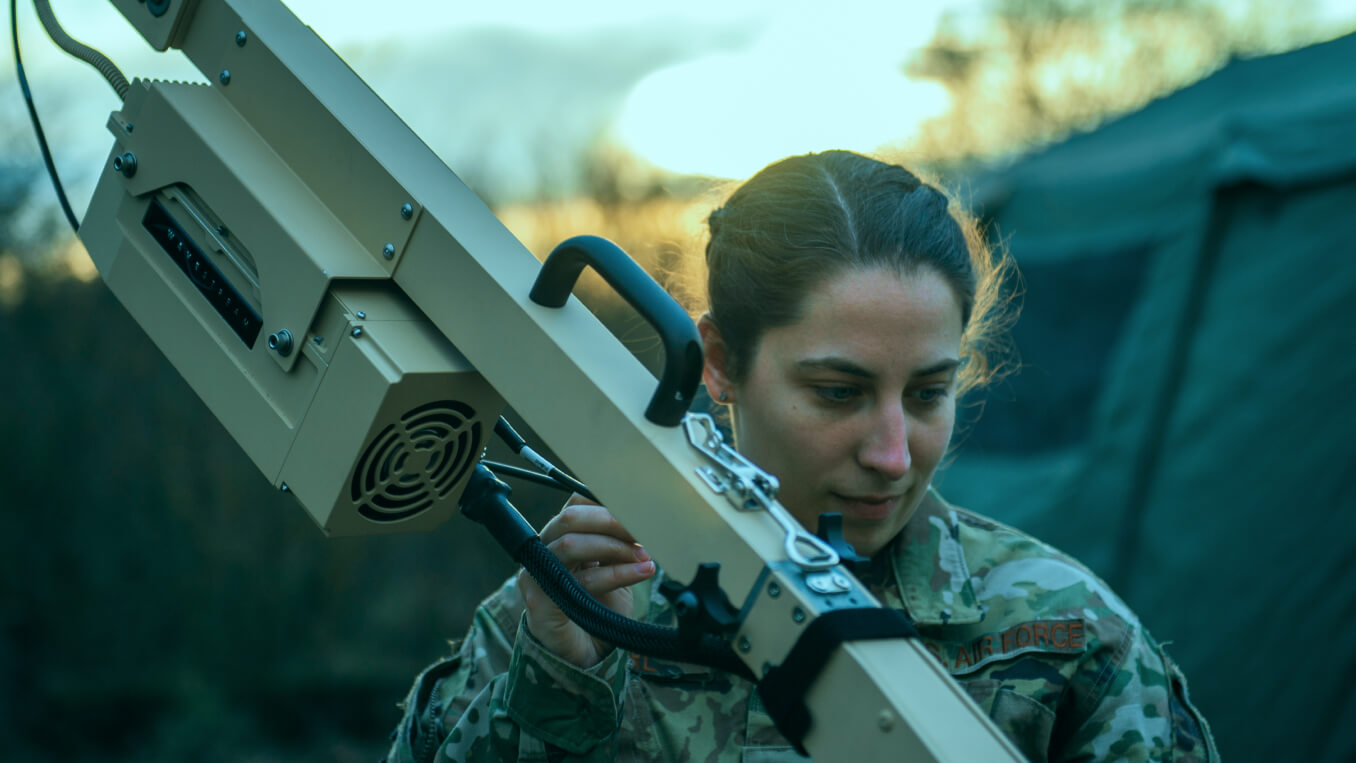 A uniformed Airman using a large piece of cyber equipment.