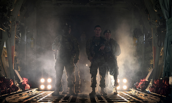 Airmen standing in the back of a large aircraft