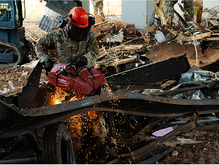 man with an automatic saw cutting a beam