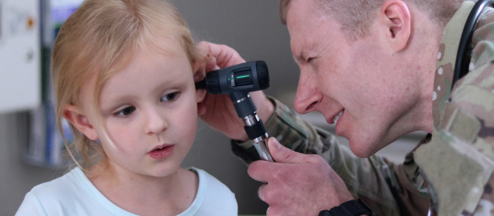 Physician looking in patient's ear