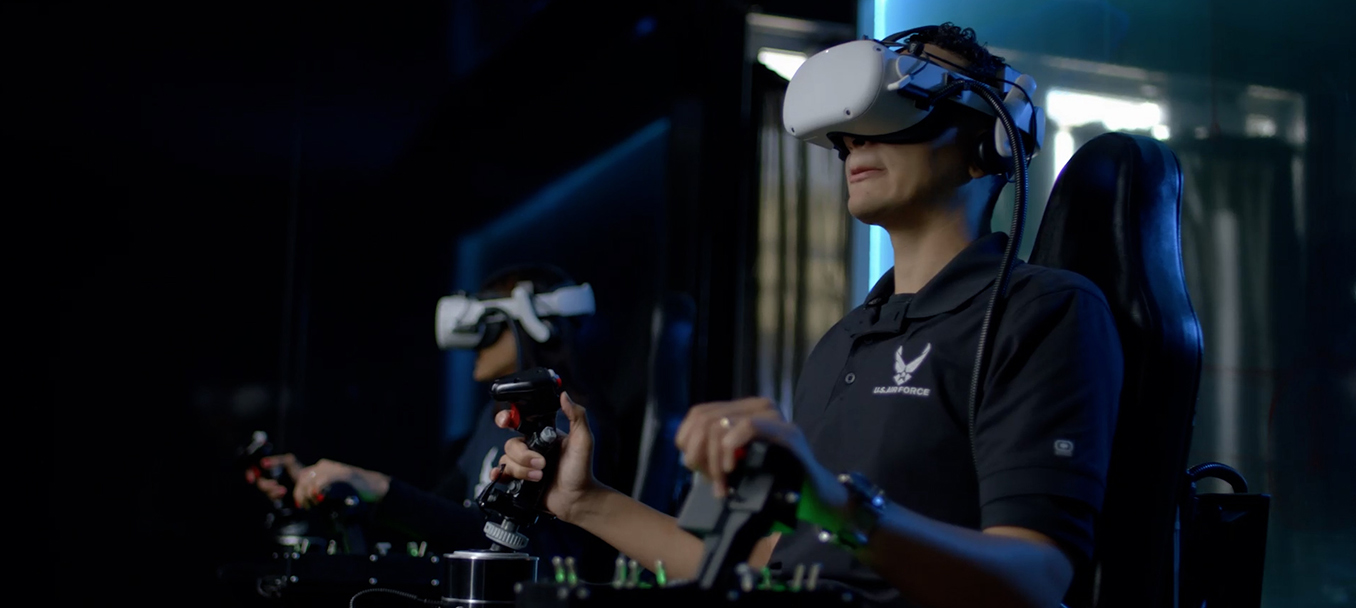 Male wearing headset and holding handheld controls