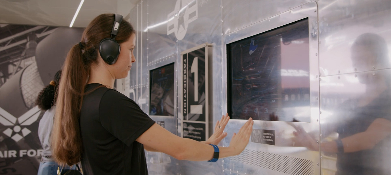 a female experiencing the Air Force Hangar mobile tour