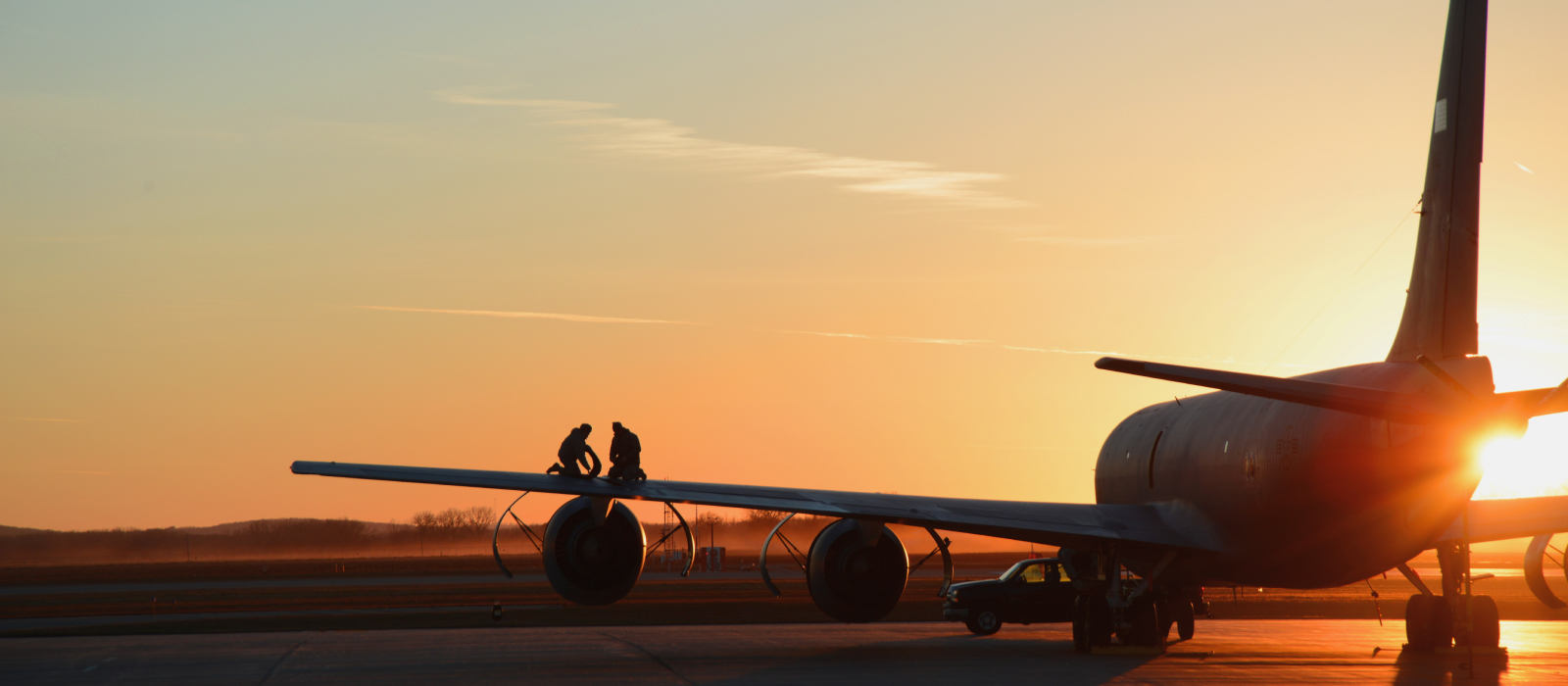 airman on aircraft wing at sunset