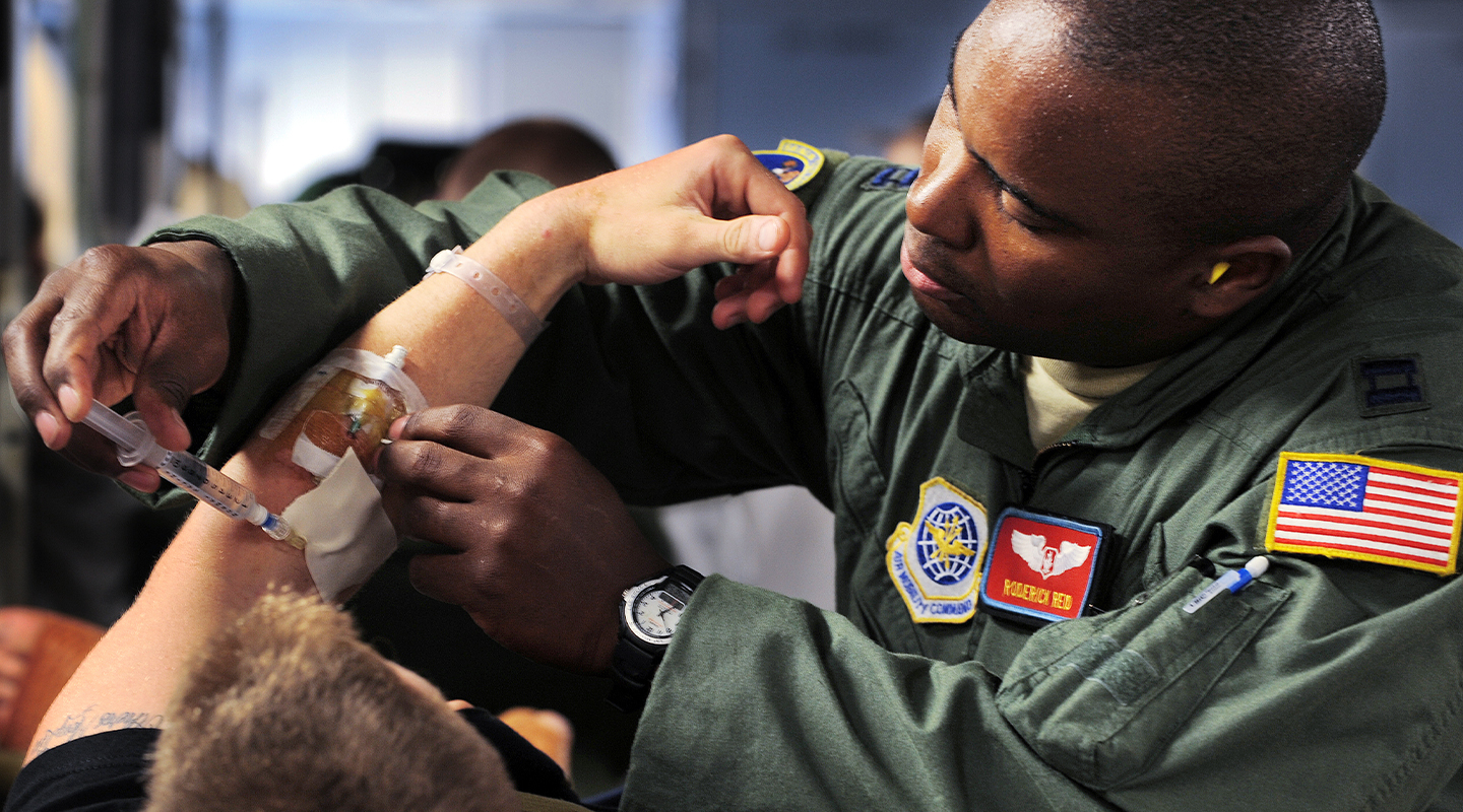 Air Force flight nurse inserting IV