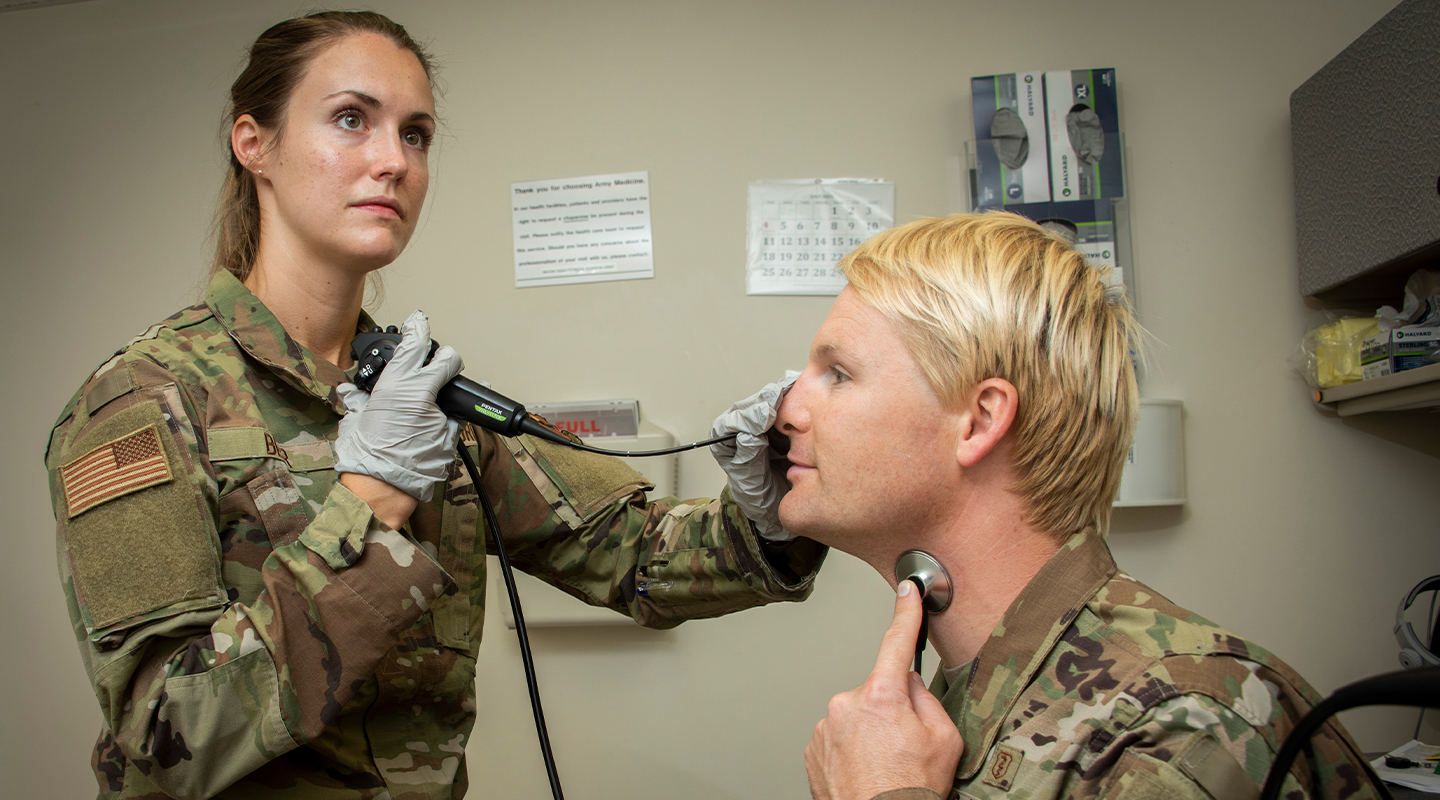 OTORHINOLARYNGOLOGIST examining a patient