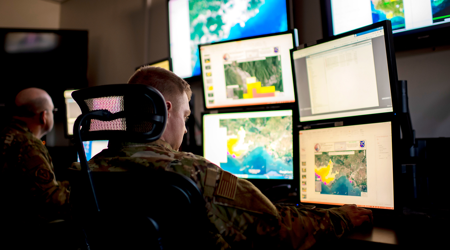 Fusion Analyst in front of screens