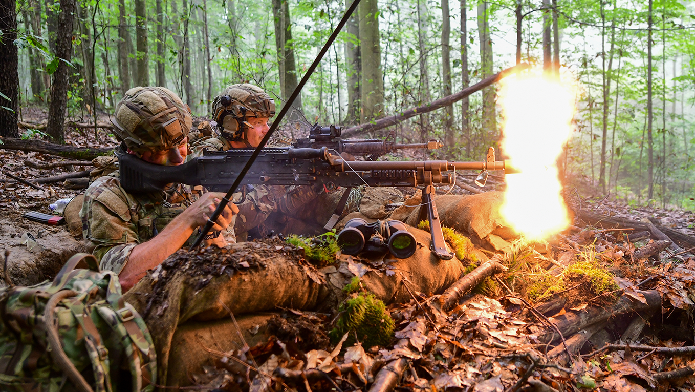two airmen using firearms aiming for their target