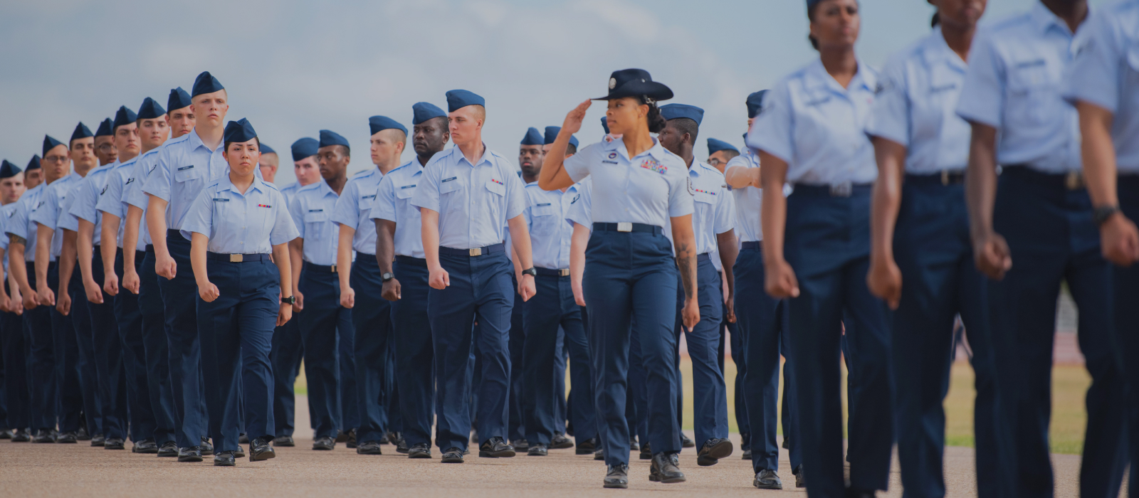 airmen marching and one saluting