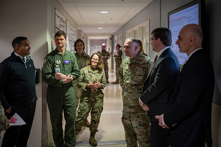 airmen standing in a hallway talking