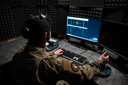 airman using a joystick and keyboard to complete a screen simulation