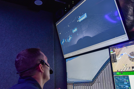 airman staring at multiple surveillance screens 