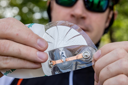 airman holding up a wearable device