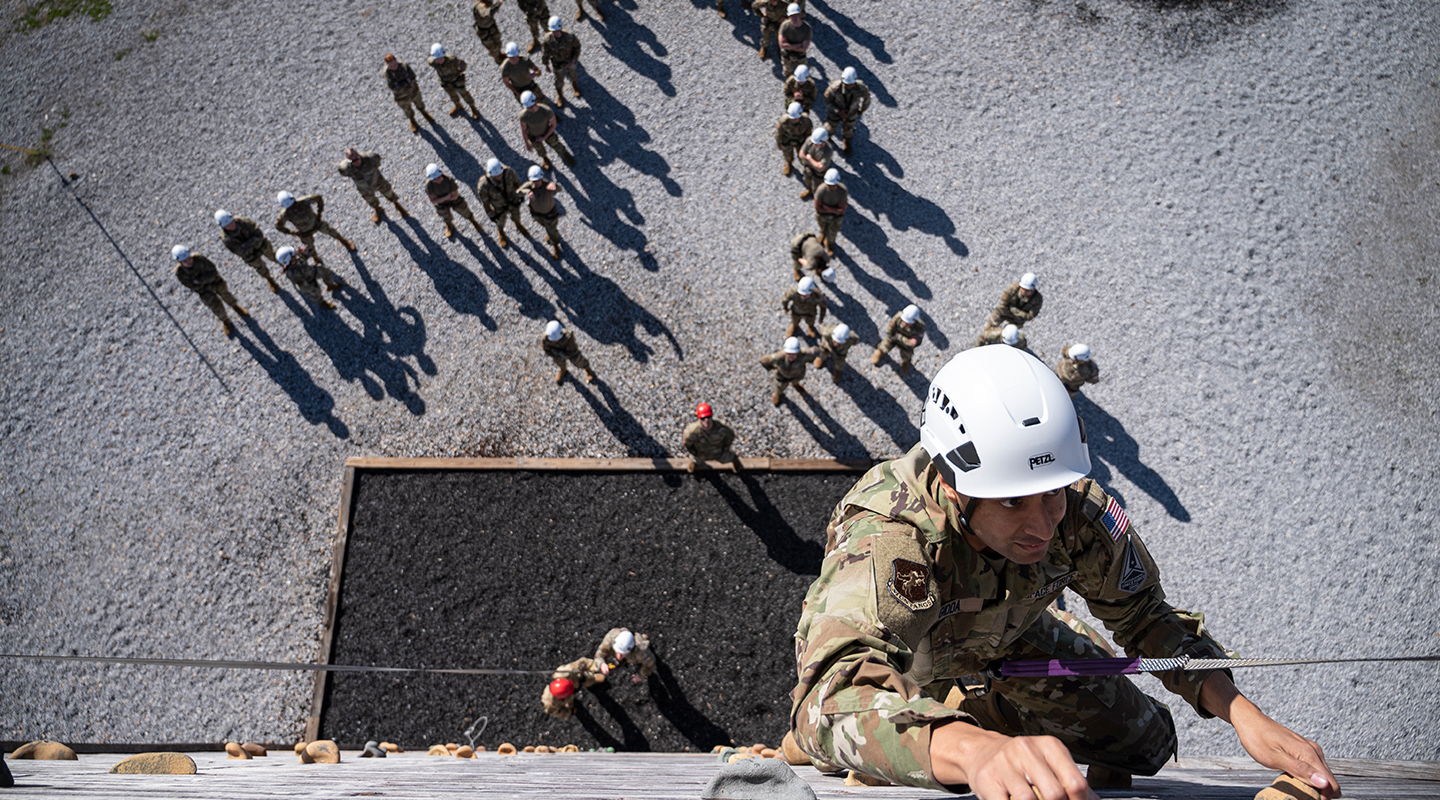 trainees climbing a wall